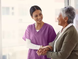 Supportive nurse and patient sharing a smile.